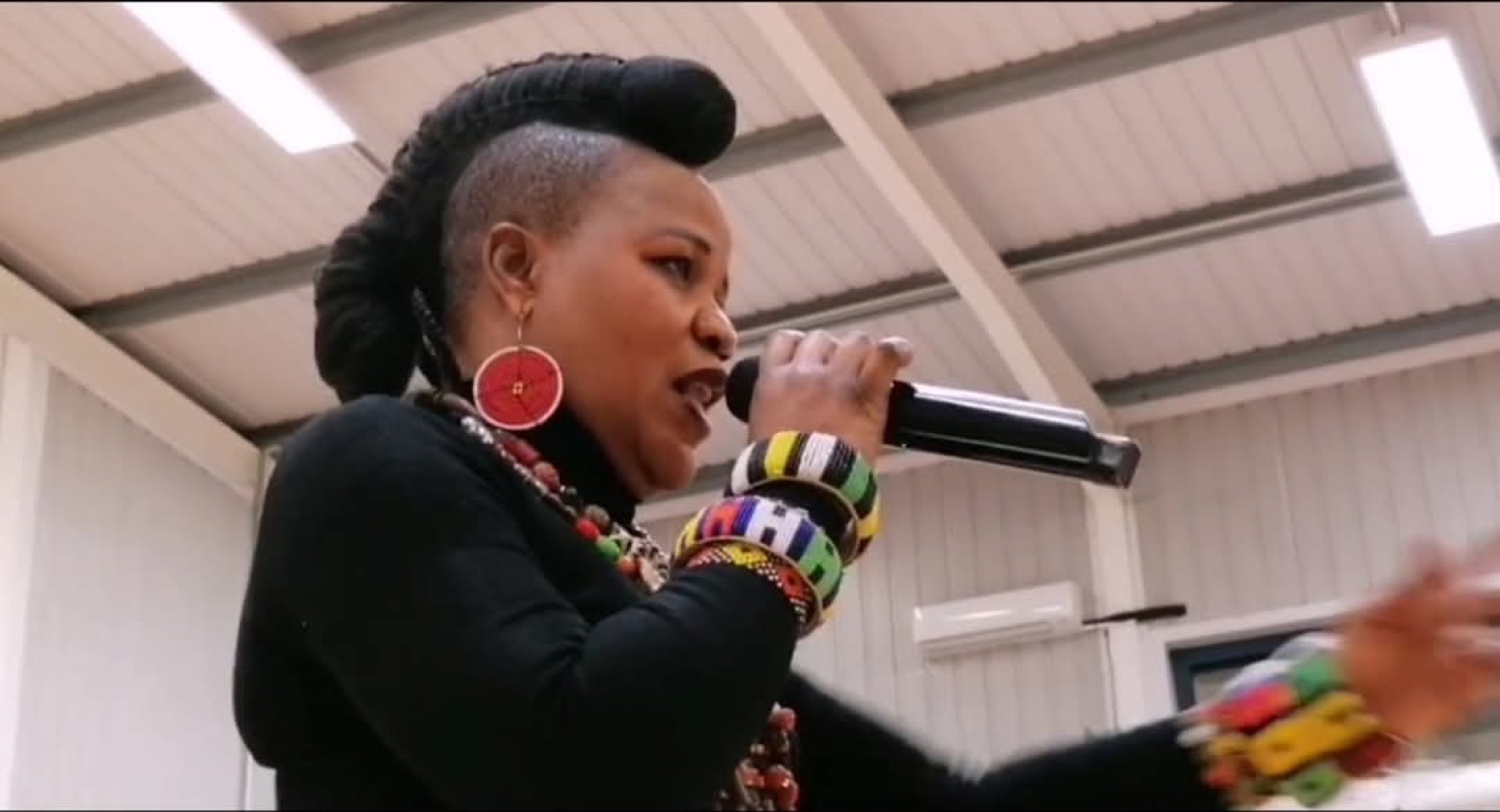 Sherifa Gunu performing live, wide shot